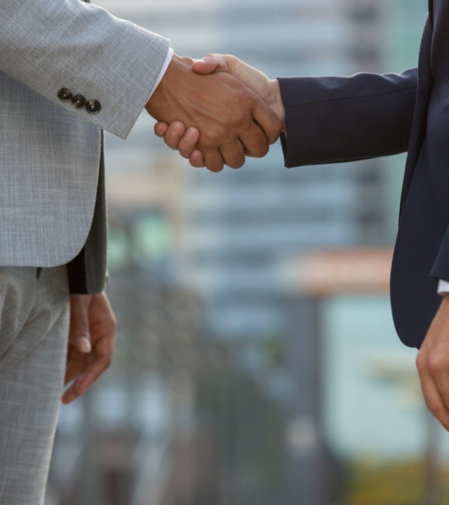 businesspeople-standing-city-street-shaking-hands (1)